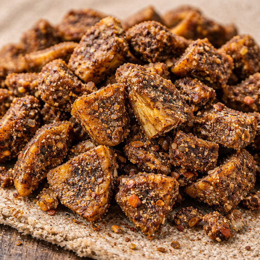 Close-up of seasoned beef chunks on a wooden surface