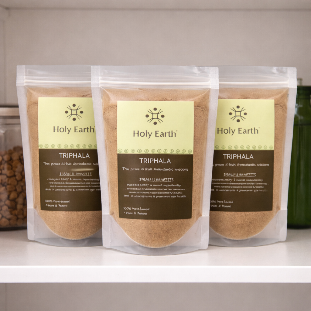 Three packages of Holy Earth Triphala on a white surface with a neutral background.
