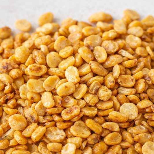 Close-up of yellow fenugreek seeds on a light background
