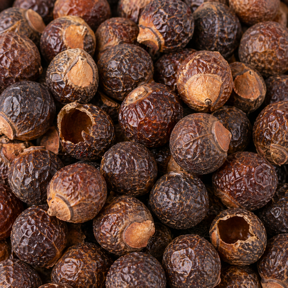 Close-up of a pile of dark brown spices with a few open pods.