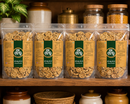 Packaged snacks with green labels on a wooden shelf with jars and containers in the background.
