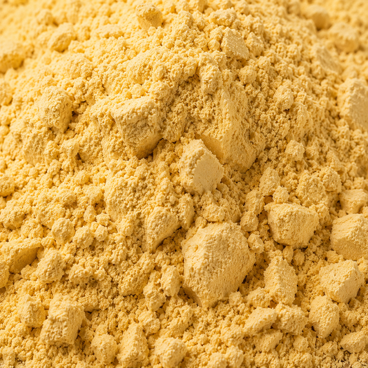 Close-up of a pile of yellow powder with a rough texture.