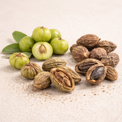 Green fruits and brown seeds on a textured surface