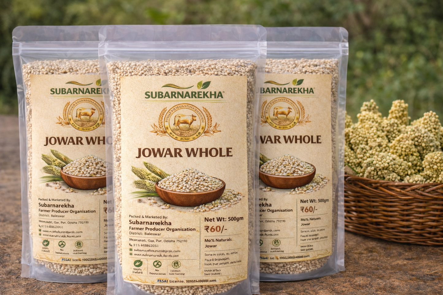 Three packages of Subarnarekha Jowar Whole on a wooden surface with a blurred natural background.
