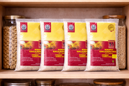 Four packages of Koraput Kallajeera rice on a shelf with jars in the background.