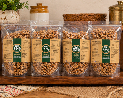 Five packages of a product with labels on a wooden surface.