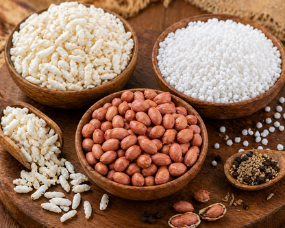 Bowls of white and brown grains on a wooden surface
