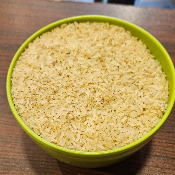 Green bowl filled with rice on a wooden surface