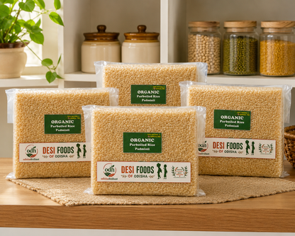Plastic bags of organic parboiled rice from Desi Foods on a wooden surface with jars in the background.