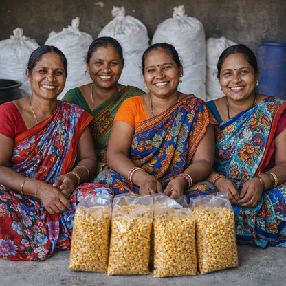 Four women in colorful traditional attire sitting behind bags of yellow grains.
