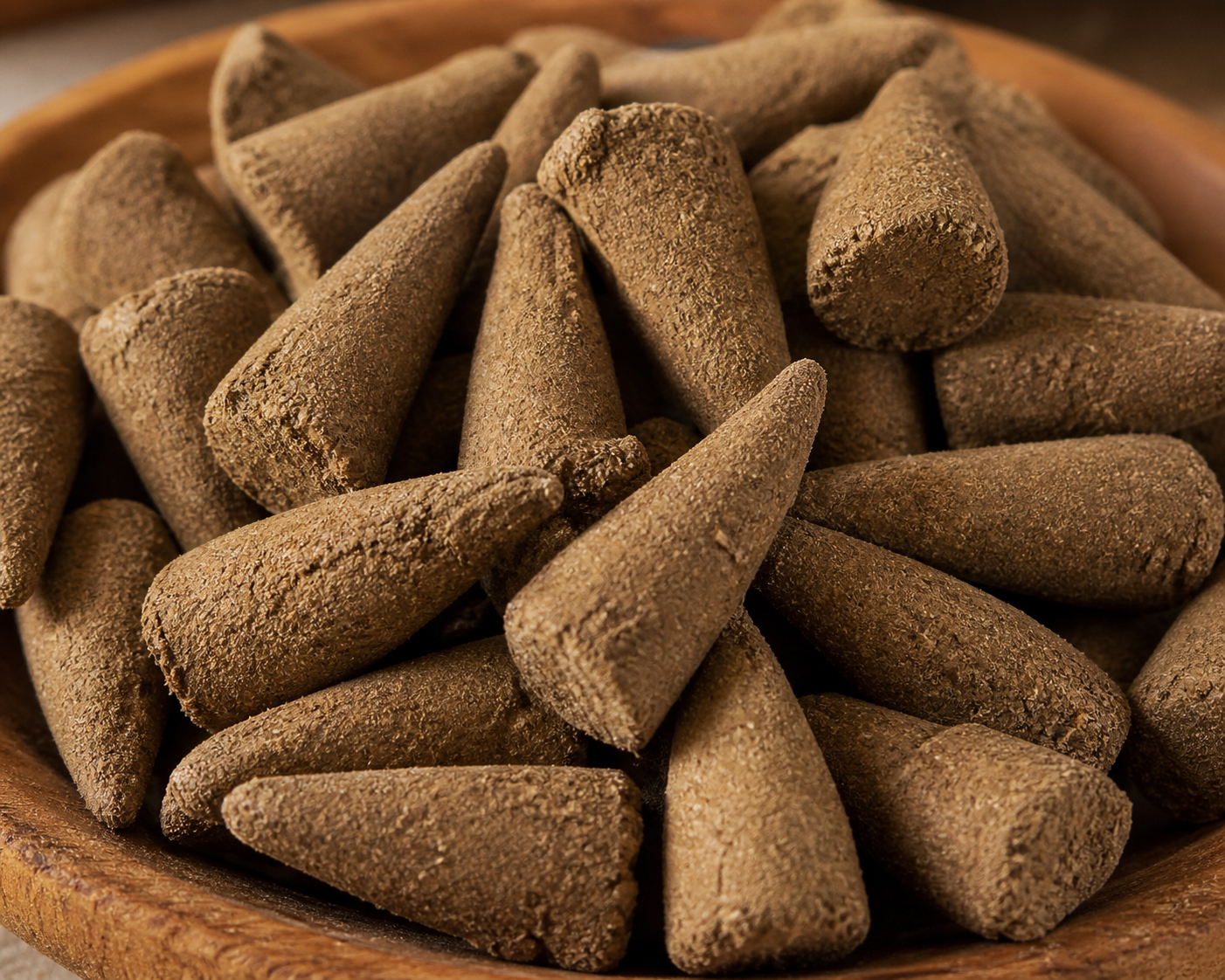 Conical incense sticks in a wooden bowl