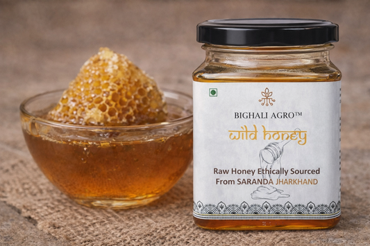 Jar of Bighali Agro wild honey with a bowl of honeycomb on a textured surface