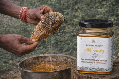 Person holding a honeycomb with honey dripping into a pot next to a jar of Bighalli Agro wild honey.