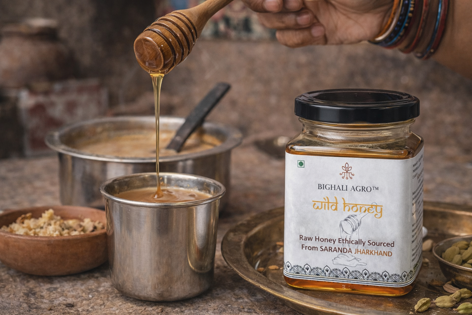 Honey being drizzled into a pot with a jar of Bighali Agro wild honey in the foreground.