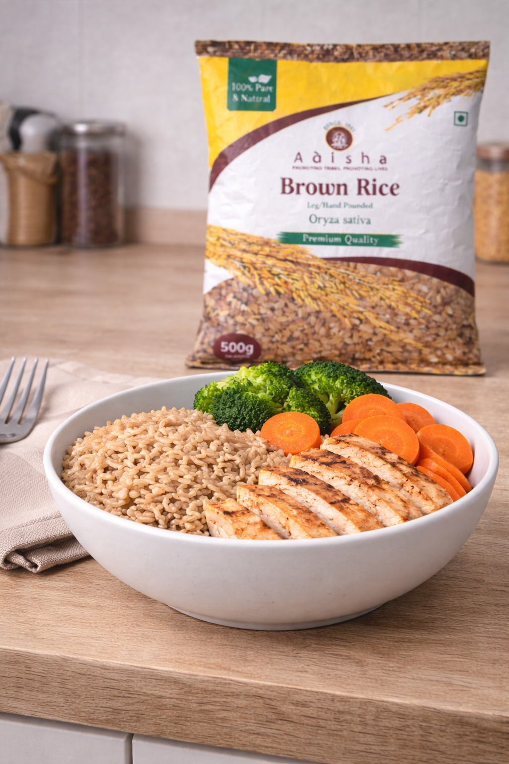 Bowl of brown rice with chicken and vegetables next to a bag of Adisha Brown Rice.