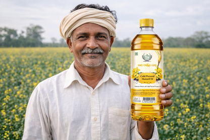 Man holding a bottle of Golden Village Farms mustard oil in a field with yellow flowers