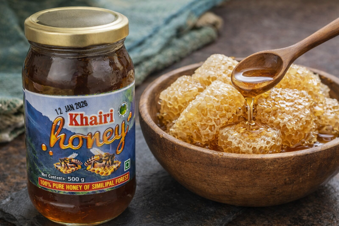 Jar of Khairi honey with a wooden spoon on honeycomb