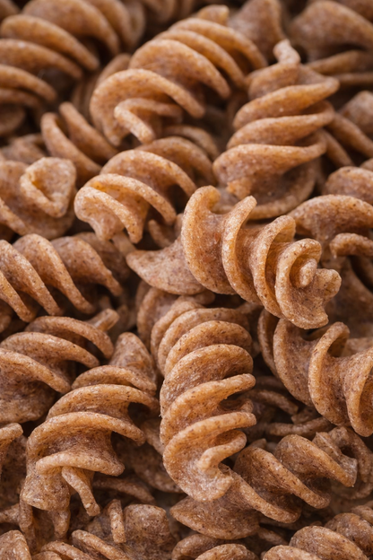Close-up of uncooked whole wheat rotini pasta