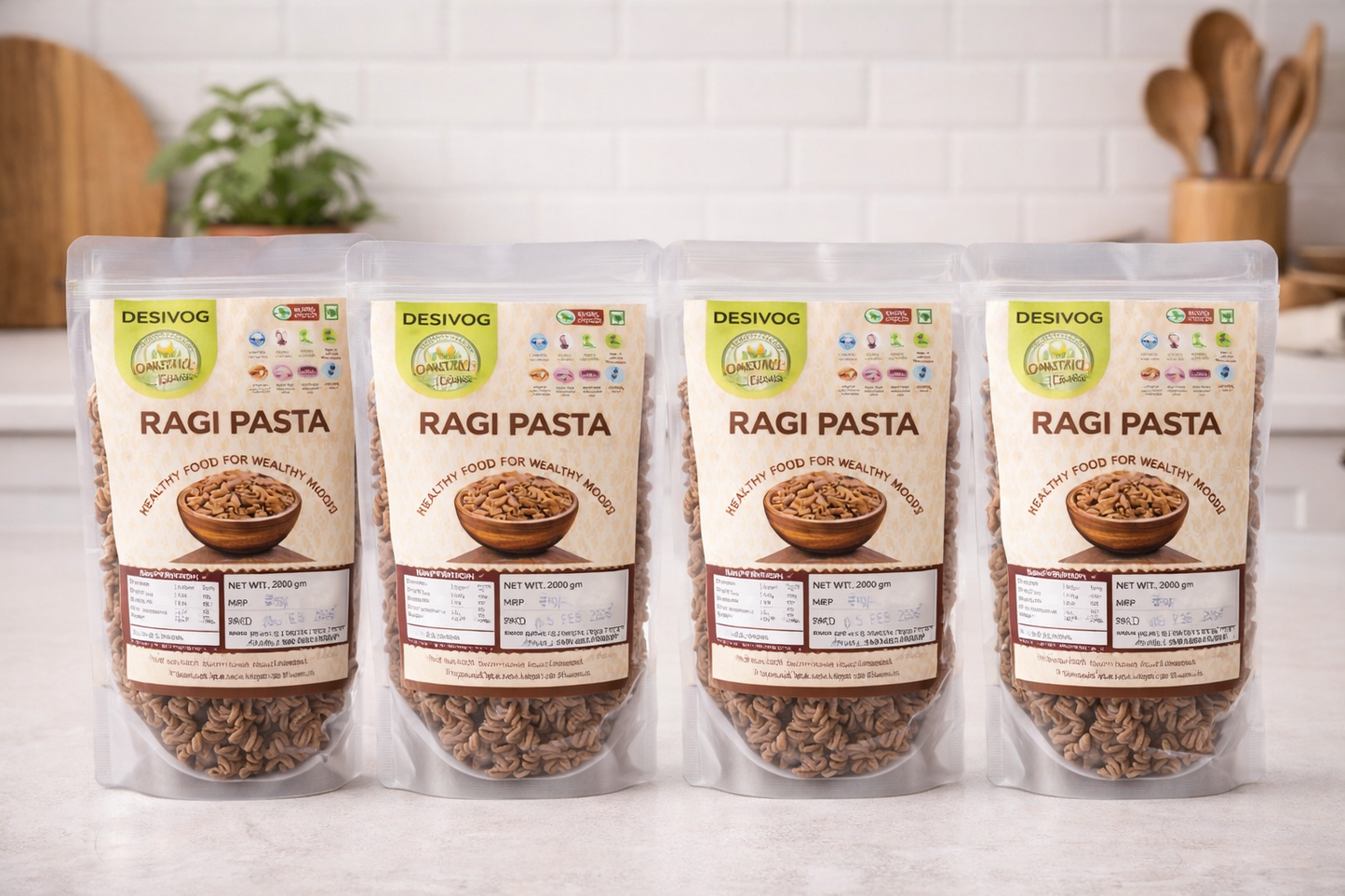 Four packages of Desivog Ragi Pasta on a kitchen counter with a white tiled wall background.