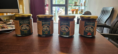 Four jars of a product with a brand label on a wooden table.