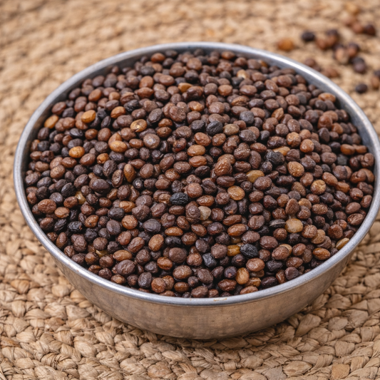 Metal bowl filled with dried seeds on a woven mat