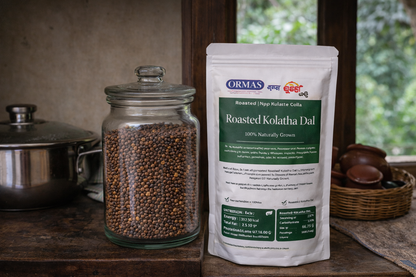 Jar of roasted kohatha dal and a package of Ormas Roasted Kohatha Dal on a wooden surface.