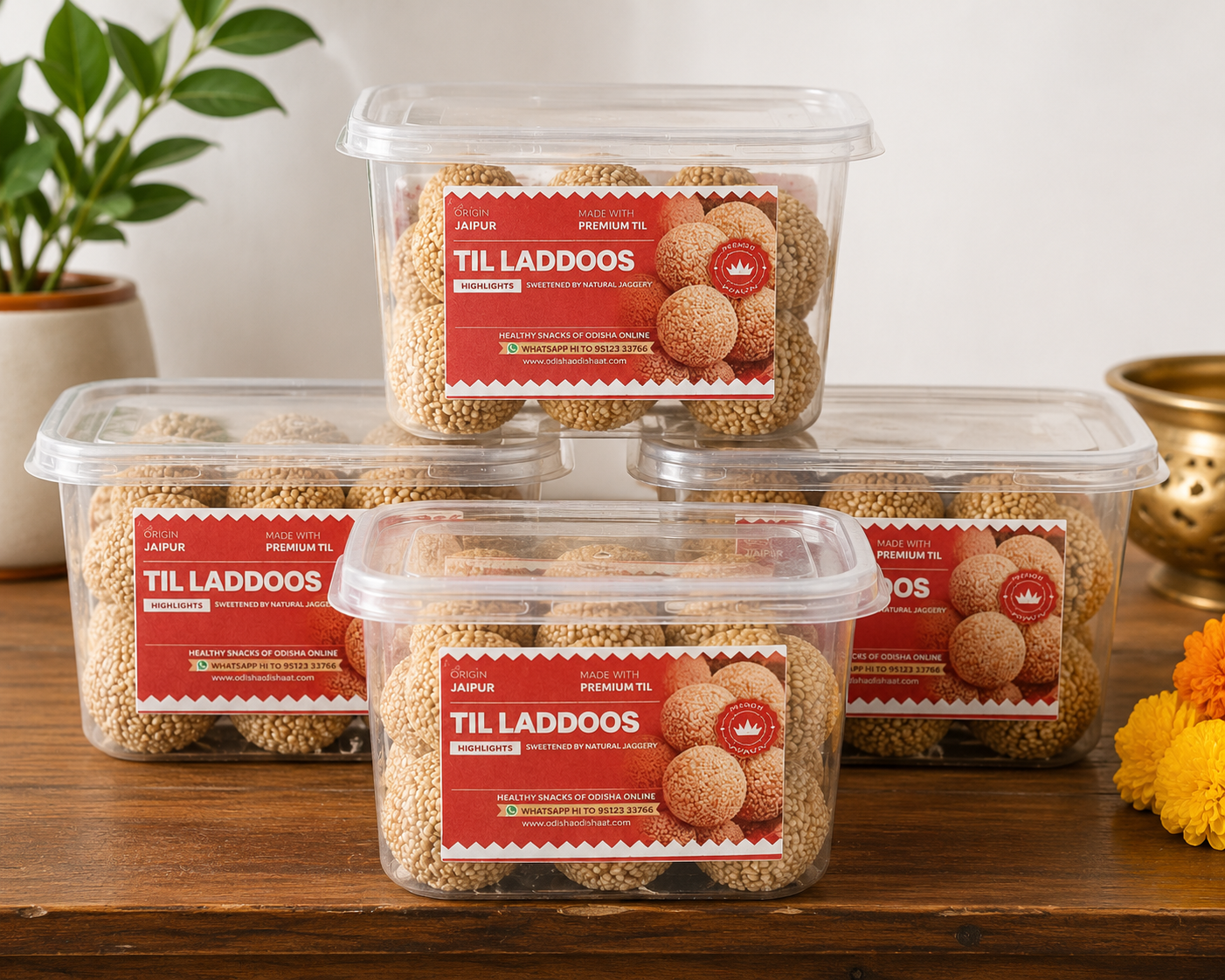 Four containers of 'Til Laddoos' with red labels on a wooden surface.